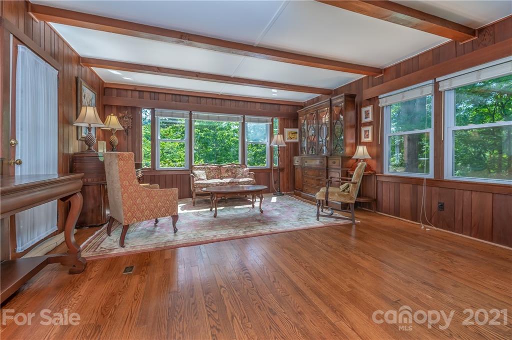 75 Hidden Hill Road Tryon, NC 28782 - Photo 14 of 36 a living room with furniture a large window and wooden floor