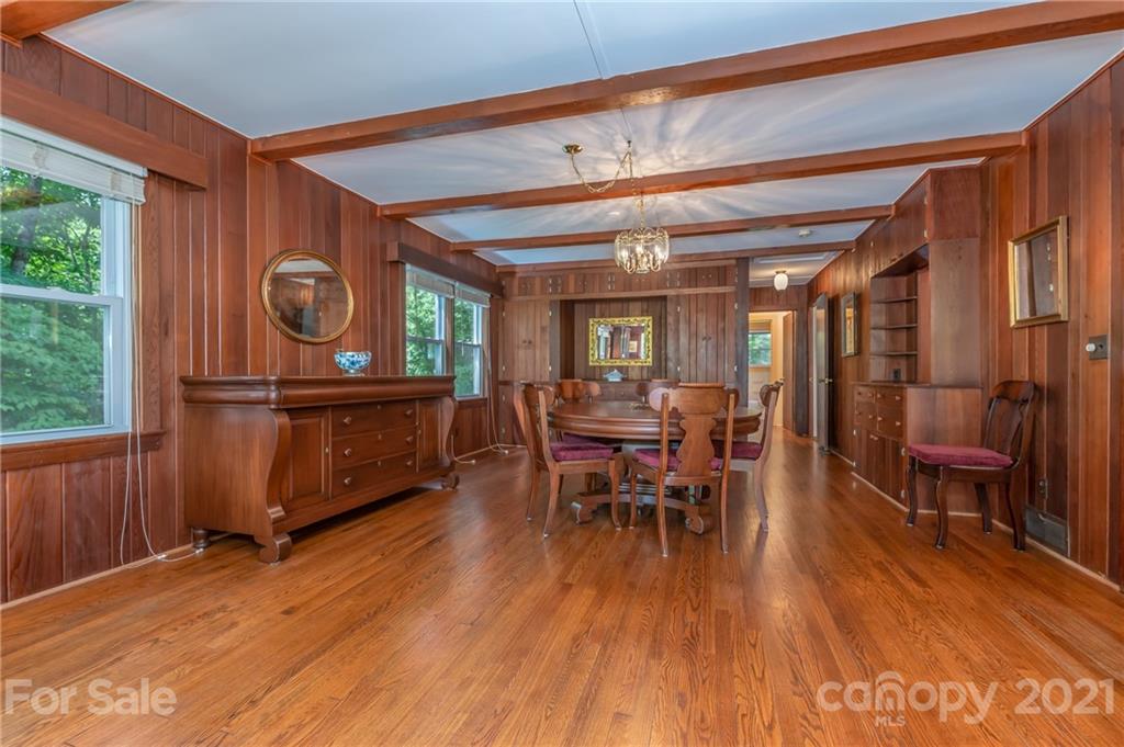 75 Hidden Hill Road Tryon, NC 28782 - Photo 15 of 36 a view of a dining room with furniture window and wooden floor
