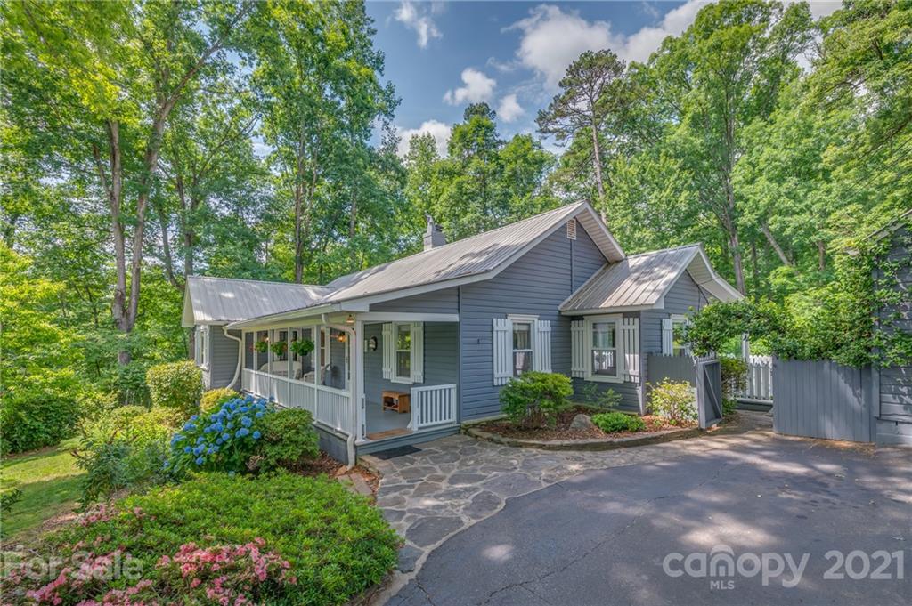 75 Hidden Hill Road Tryon, NC 28782 - Photo 3 of 36 a front view of a house with garden
