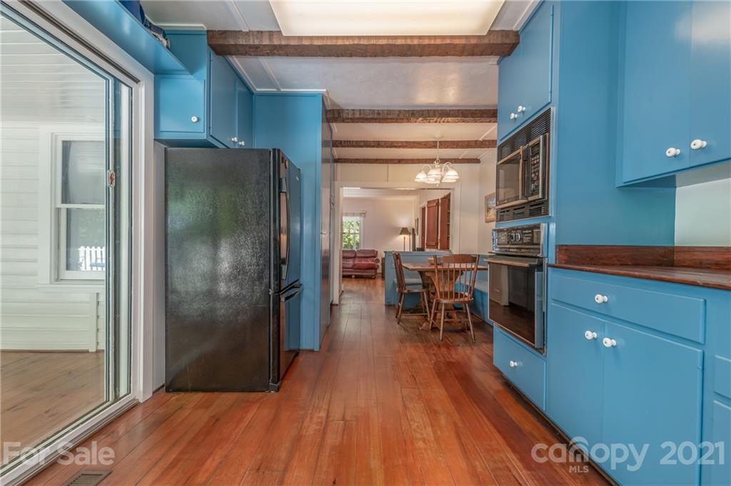 75 Hidden Hill Road Tryon, NC 28782 - Photo 23 of 36 a kitchen with stainless steel appliances granite countertop a refrigerator dining table and chairs