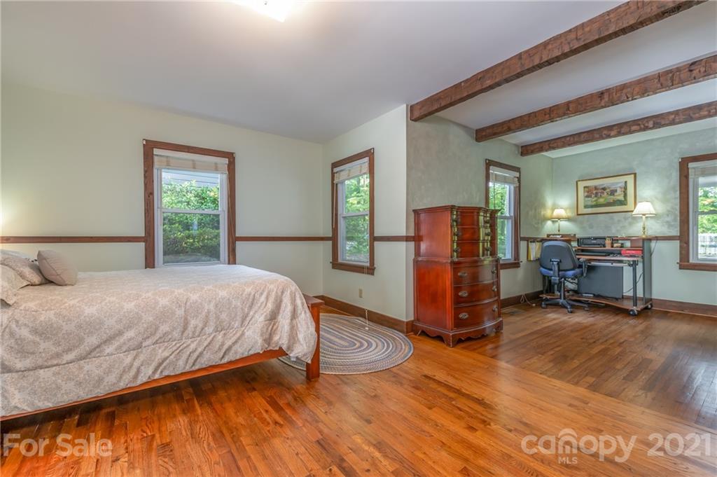 75 Hidden Hill Road Tryon, NC 28782 - Photo 25 of 36 a bedroom with a bed and wooden floor