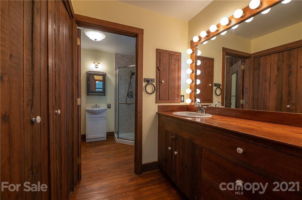 75 Hidden Hill Road Tryon, NC 28782 - Photo 28 of 36 a bathroom with a sink and a large mirror