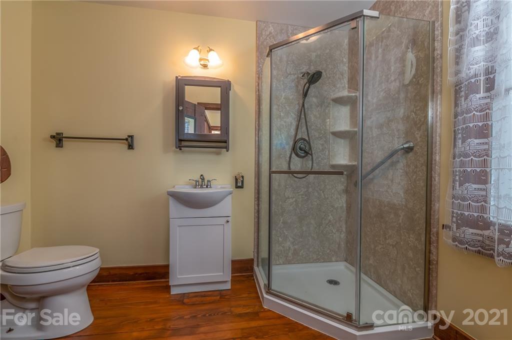 75 Hidden Hill Road Tryon, NC 28782 - Photo 29 of 36 a bathroom with a toilet and a shower