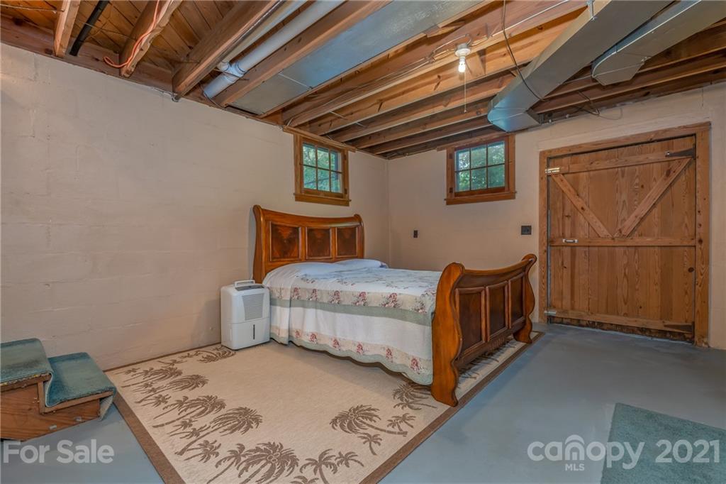 75 Hidden Hill Road Tryon, NC 28782 - Photo 35 of 36 a bedroom with a bed next to a window