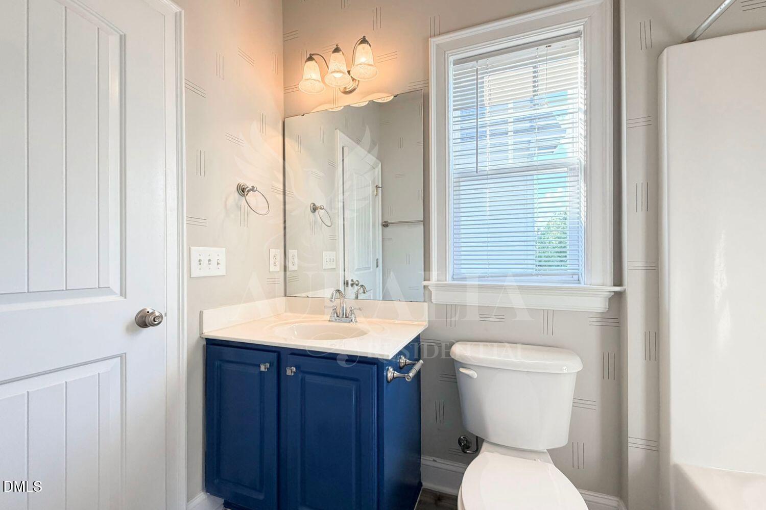 7754 ACC Boulevard Raleigh, NC 27617 - Photo 27 of 41 a bathroom with a toilet sink and mirror