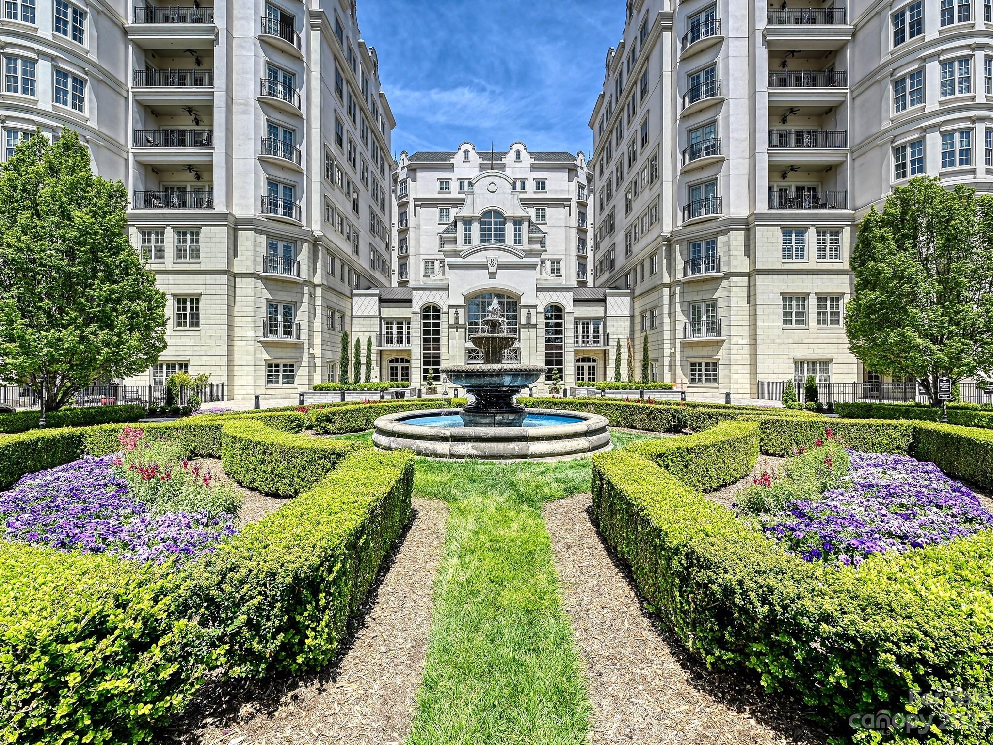 a view of a fountain in front of buildings