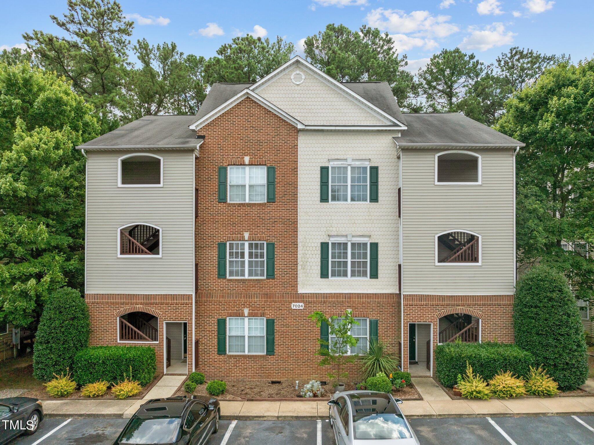 7024 Sandy Forks Road, Unit 201 Raleigh, NC 27615 - Photo 1 of 42 a view of a yard in front of a house