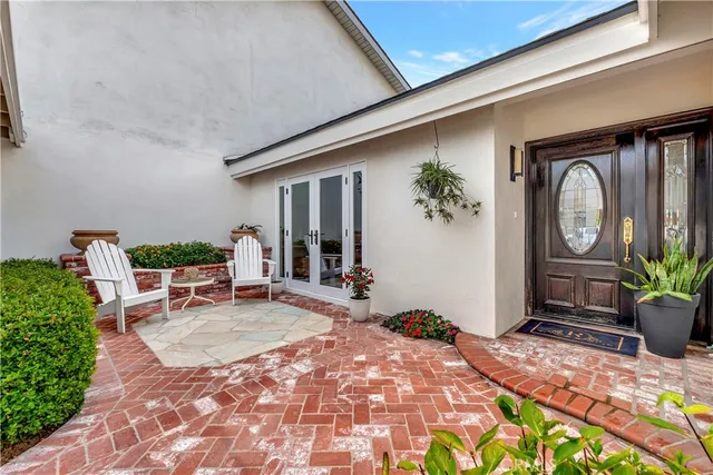 a view of a house with backyard porch and sitting area