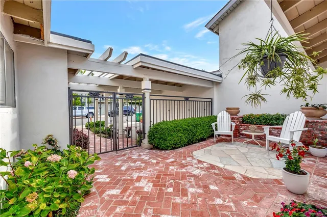 a view of a chair and tables in the patio in front of a house