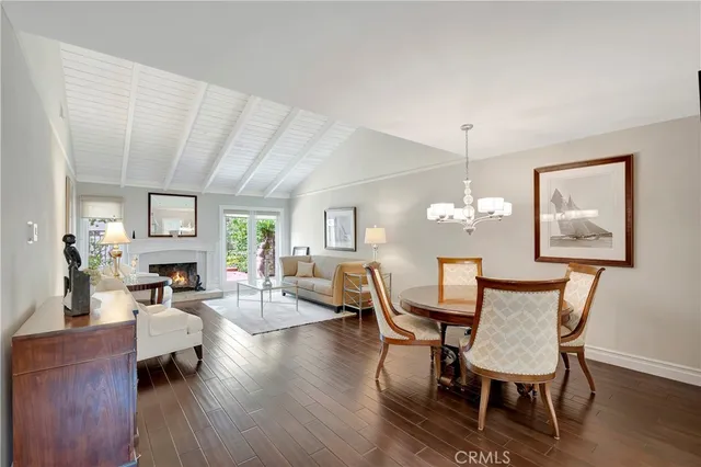 a view of a dining room with furniture a chandelier and wooden floor