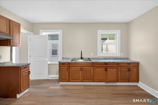 a spacious bathroom with a granite countertop sink and a mirror