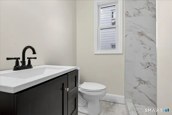 a bathroom with a sink a toilet and a shower