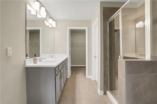 a bathroom with a sink a mirror and a shower