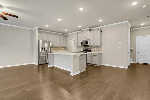 a kitchen with stainless steel appliances a refrigerator sink and cabinets
