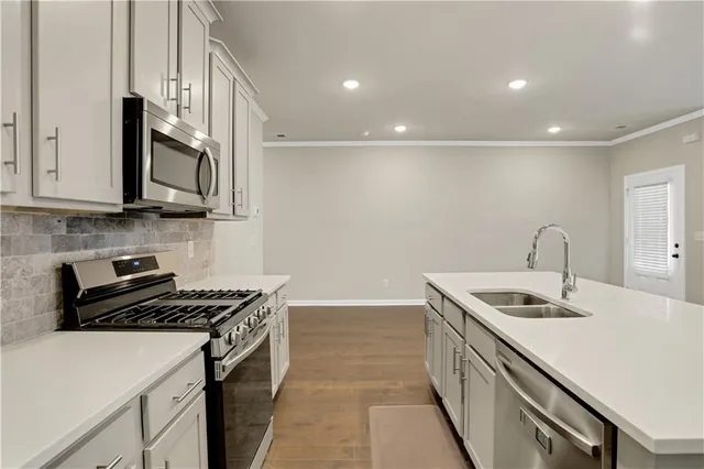 a kitchen that has a sink and a stove