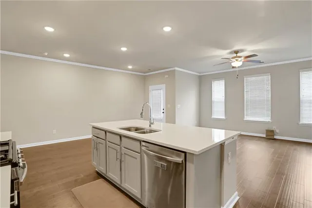 a kitchen with a sink stove and cabinets