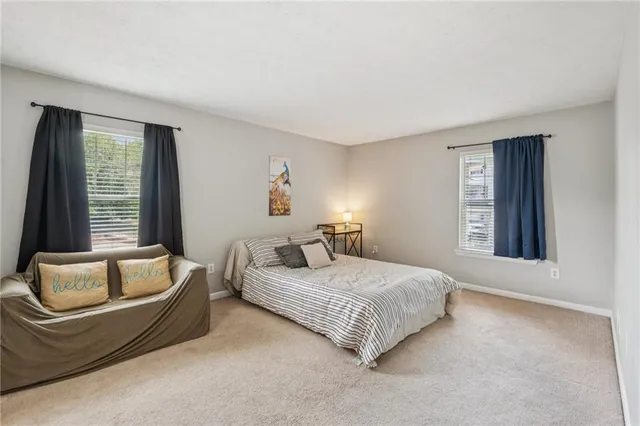 a bedroom with a bed and a couch with window