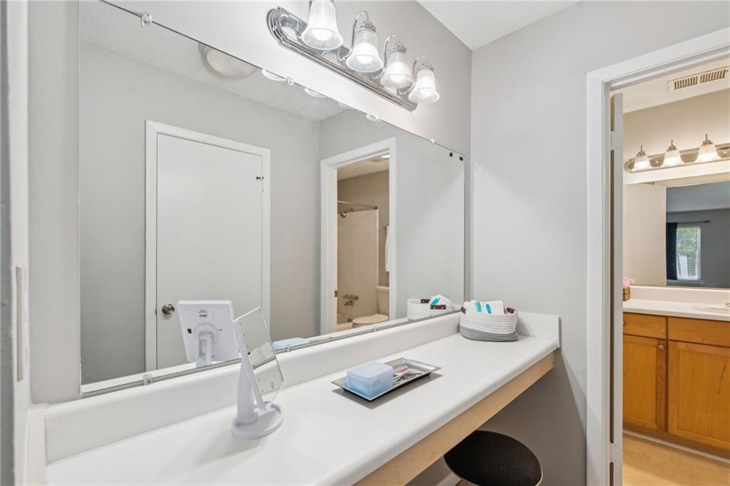 1150 Collier Road Northwest, Unit 16H Atlanta, GA 30318 - Photo 12 of 27 a bathroom with a sink vanity and a mirror
