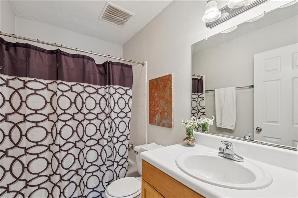 1150 Collier Road Northwest, Unit 16H Atlanta, GA 30318 - Photo 16 of 27 a bathroom with a sink and a mirror