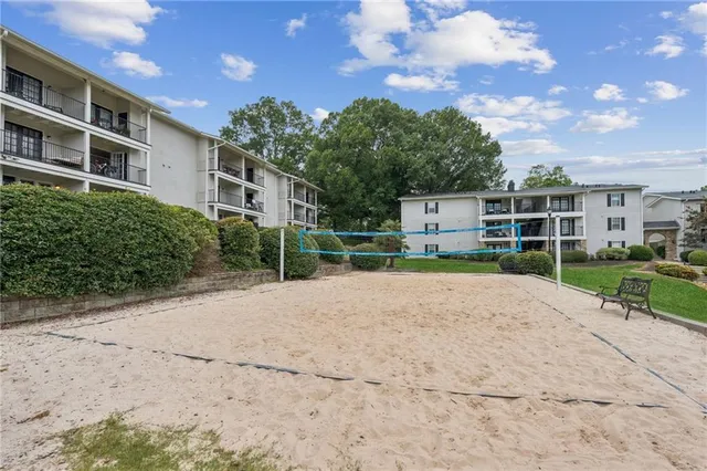 a view of a patio with swimming pool and a chairs and tables