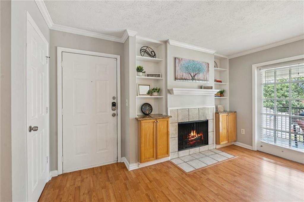 1150 Collier Road Northwest, Unit 16H Atlanta, GA 30318 - Photo 3 of 27 a view of an empty room with window and fireplace