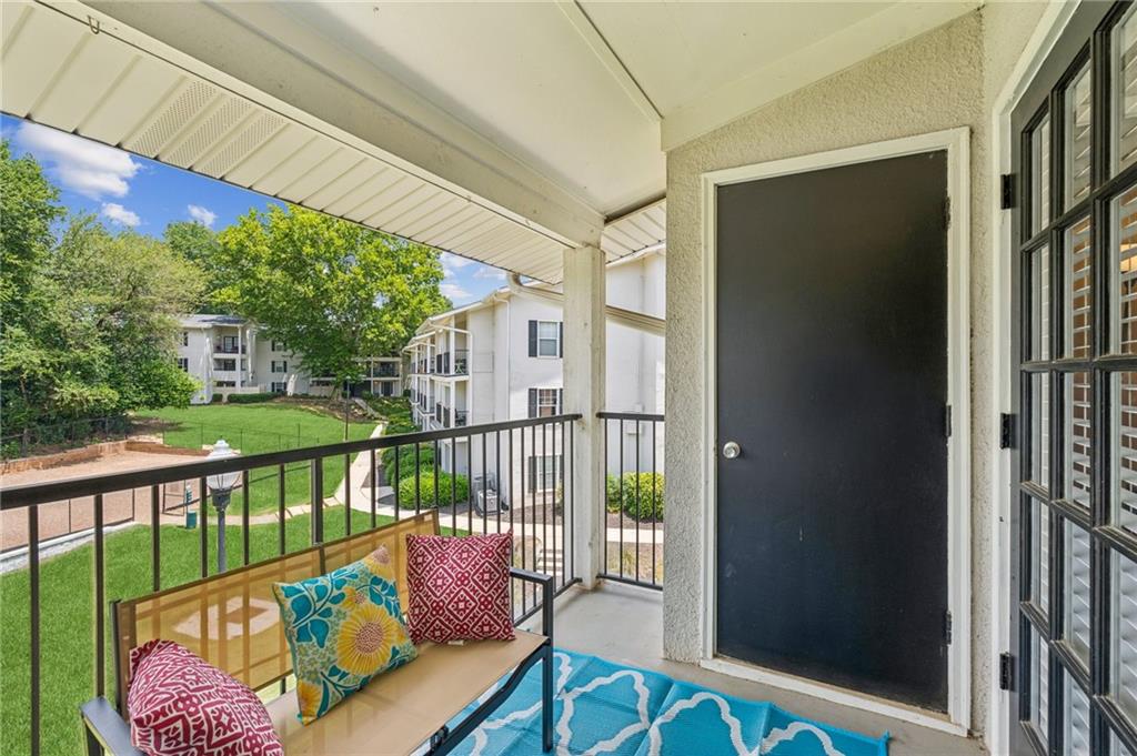 1150 Collier Road Northwest, Unit 16H Atlanta, GA 30318 - Photo 10 of 27 a balcony with furniture and potted plants
