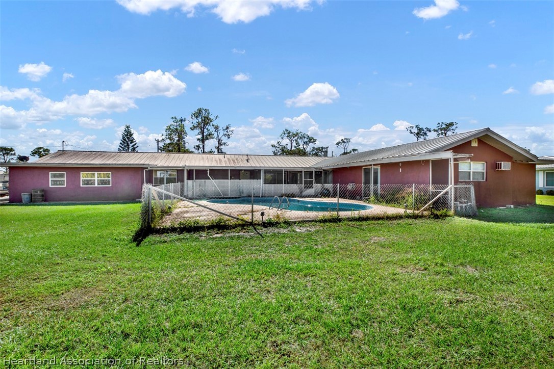 3204 Golfview Road Sebring, FL 33875 - Photo 34 of 36 a view of a house with a backyard and a patio