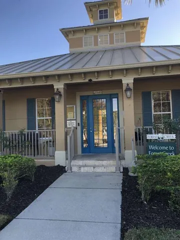 a front view of a house with yard swimming pool and outdoor seating