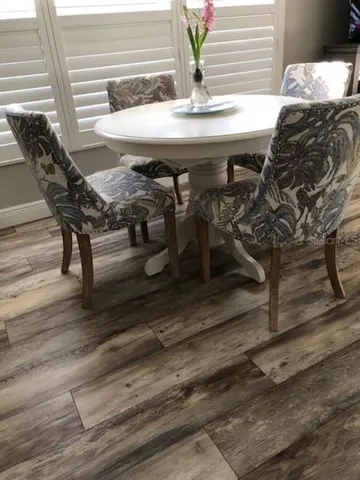 a view of a dining room with furniture and wooden floor