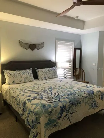 a bedroom with a bed and dresser with mirror