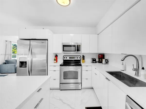 a kitchen with a sink a stove and refrigerator