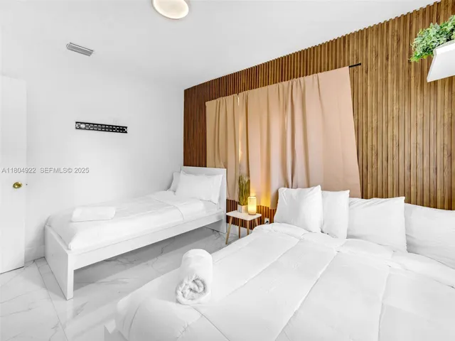 a bedroom with a bed and a mirror