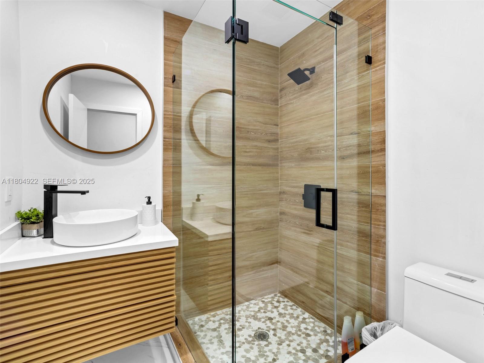 421 West Pembroke Road Hallandale Beach, FL 33009 - Photo 8 of 24 a bathroom with a sink a toilet and shower