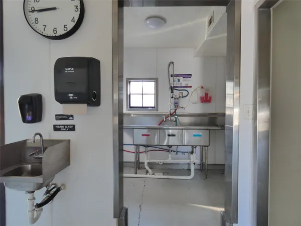 a kitchen with a refrigerator and a sink