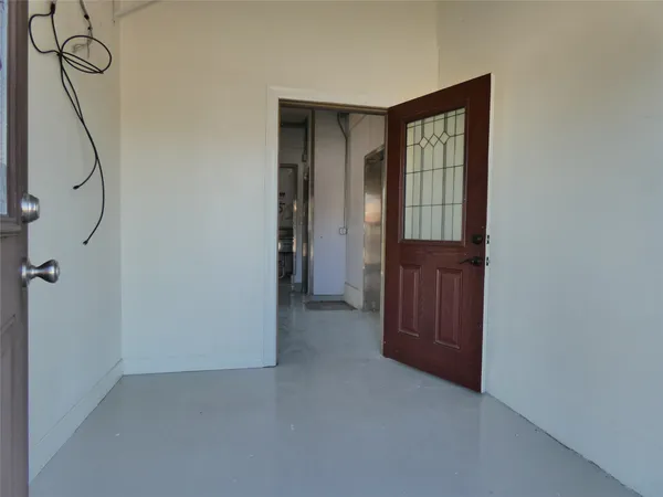 a view of an entryway with wooden floor