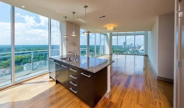 a view of a room with wooden floor and outdoor space