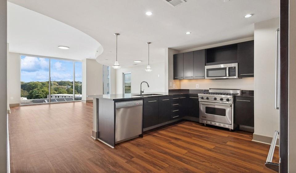 2171 Peachtree Road Northwest, Unit 1B1BA Atlanta, GA 30309 - Photo 4 of 17 a large kitchen with stainless steel appliances granite countertop a stove a sink and a refrigerator