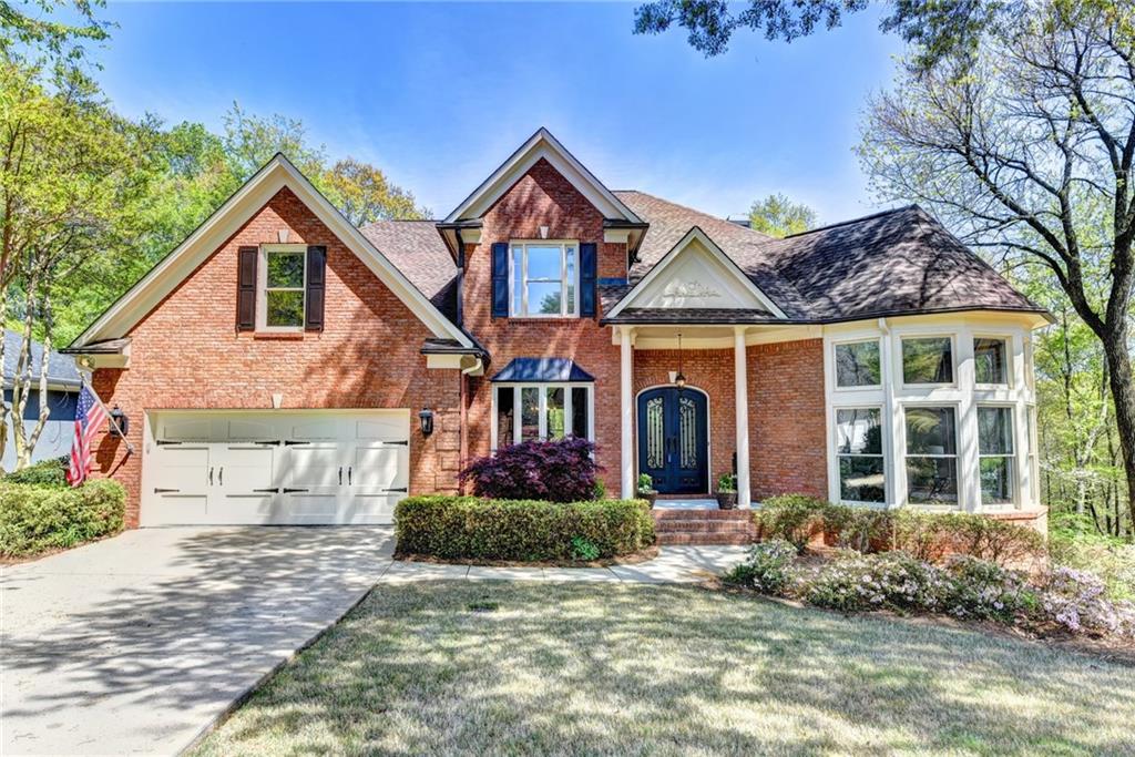 Estate living in Olde Atlanta Club. 3-side brick executive Chattahoochee River 2.45 acre home.  