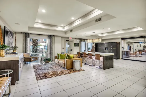a living room with furniture a large window and a dining table