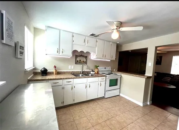 a kitchen with stainless steel appliances granite countertop a sink and cabinets