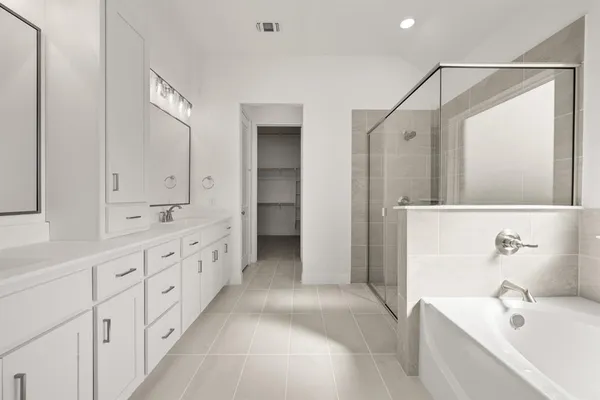 a bathroom with double vanity sink a mirror and a shower