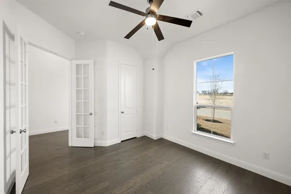 an empty room with wooden floor and wooden floor