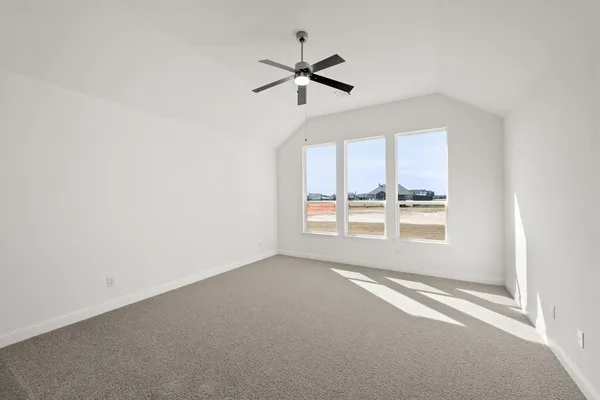 an empty room with a window and a ceiling fan