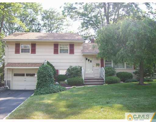 32 Overhill Road Matawan, NJ 07747 - Photo 1 of 8 a front view of a house with a garden