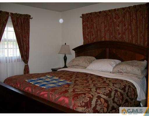 32 Overhill Road Matawan, NJ 07747 - Photo 4 of 8 a bedroom with a bed and a window
