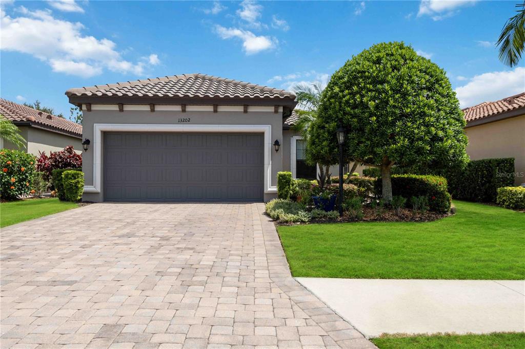13202 Torresina Terrace Lakewood Ranch, FL 34211 - Photo 1 of 35 a front view of a house with a garden