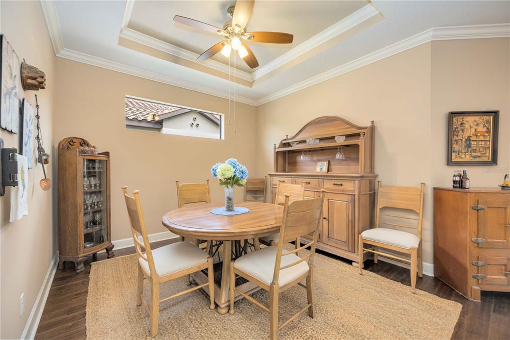 13202 Torresina Terrace Lakewood Ranch, FL 34211 - Photo 11 of 35 a view of a dining room with furniture and a chandelier
