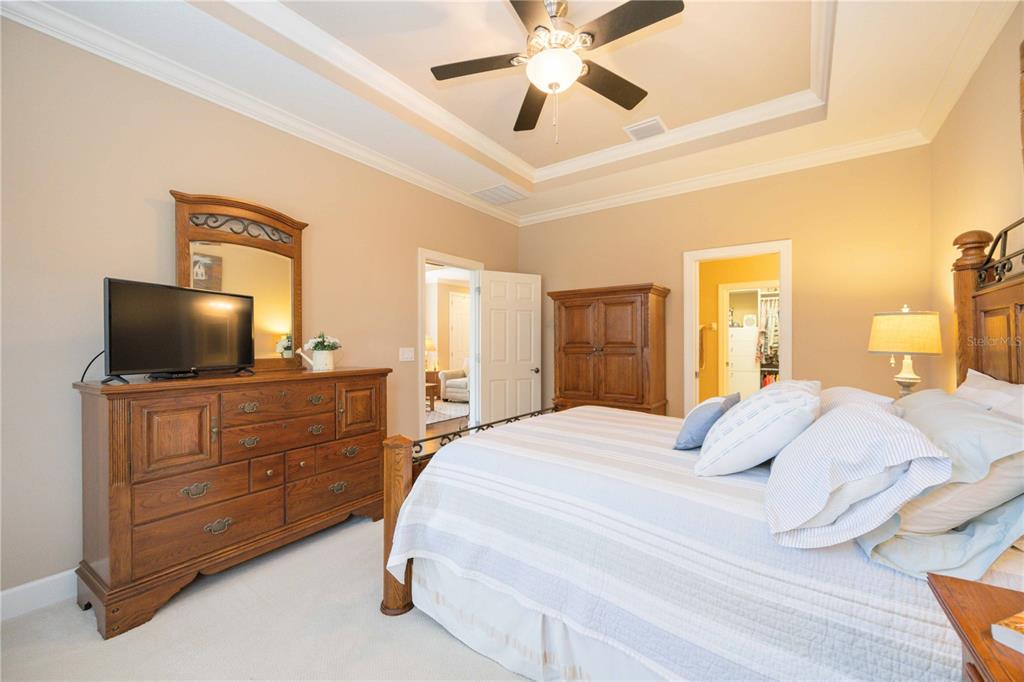 13202 Torresina Terrace Lakewood Ranch, FL 34211 - Photo 13 of 35 a bedroom with a bed and a flat screen tv