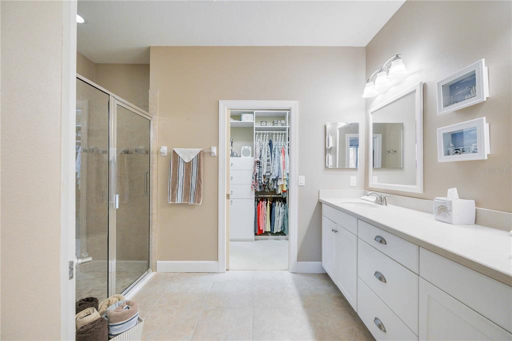 13202 Torresina Terrace Lakewood Ranch, FL 34211 - Photo 14 of 35 a spacious bathroom with a double vanity sink a mirror and a shower