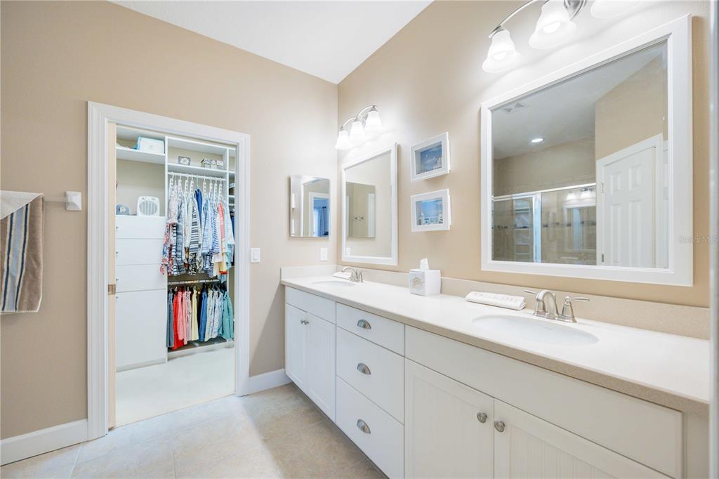 13202 Torresina Terrace Lakewood Ranch, FL 34211 - Photo 15 of 35 a en suite bathroom with a double vanity sink a large mirror and a shower